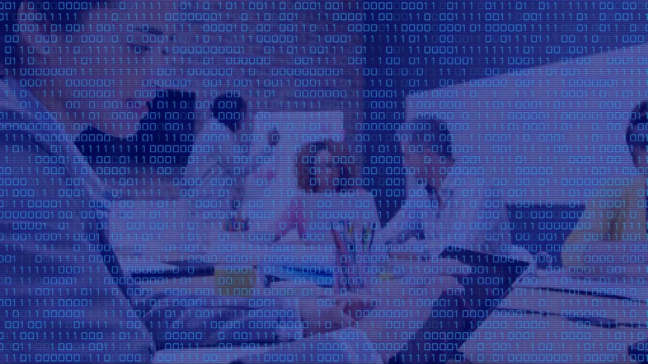 Animation of binary code over caucasian woman and coworkers in office