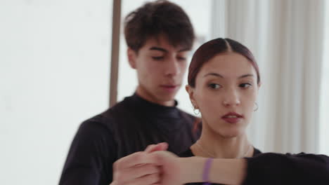 young ballet couple performing pirouette during rehearsal
