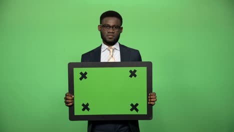 young african male holding chromakey board
