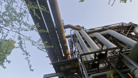 top-view-on-three-big-old-pipes-at-evening-sky-in-historic-steel-mill-landscape-park,-Duisburg,-Germany