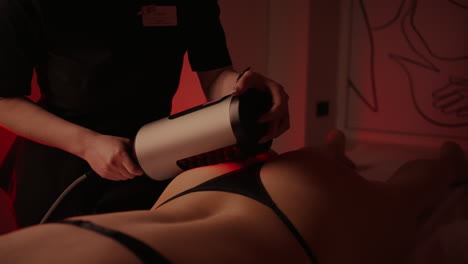 woman receiving a red light therapy treatment at a spa