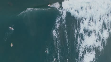 aerial top down drone view of surfers la bocana el tunco el salvador