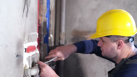 a plumber fixing pipes in a building