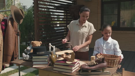 woman and girl organizing yard sale