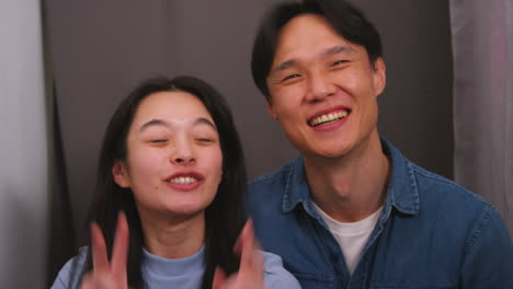 couple in photo booth having fun posing for portrait and pulling faces in real time 1