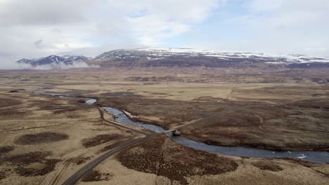 High-Flying-clip-towards-a-bridge-the-Vididalsa-River-over-dry-autumn-countryside