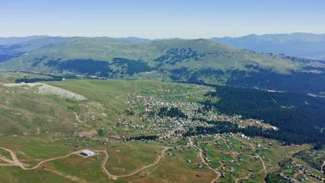 rural landscape with village among mountain expanse on sunny day in georgia