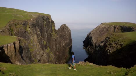 man walking on the edge of a cliff