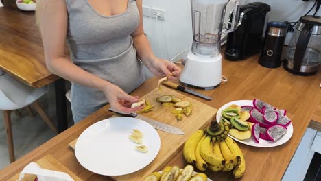 woman preparing a fruit smoothie