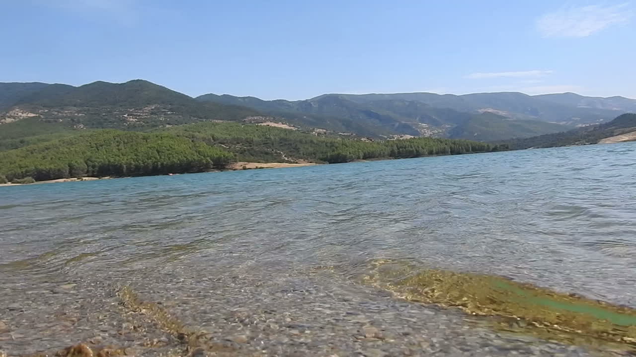 The green trees on the side of the mountain beside the lake dam reservoir ,Morocco 