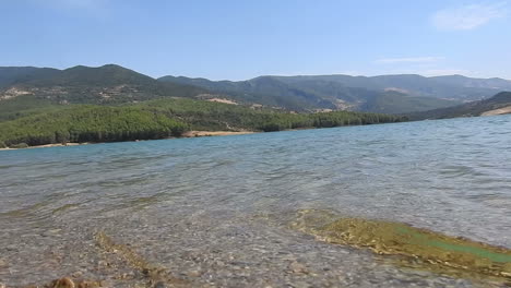 the green trees on the side of the mountain beside the lake dam reservoir ,morocco