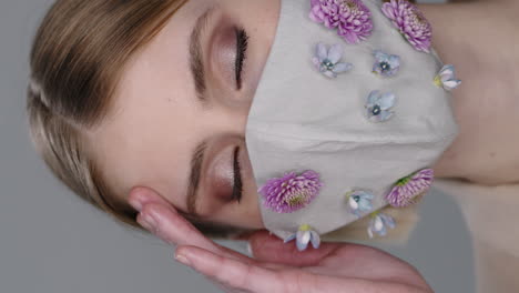 vertical portrait of woman in stylish face mask with flowers