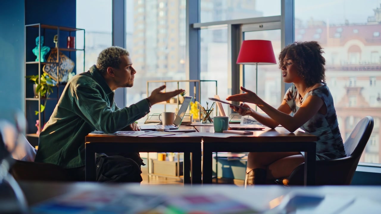 Man woman heated argument office. Colleagues arguing about paperwork at table
