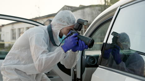 forensic scientist photographing evidence at a crime scene