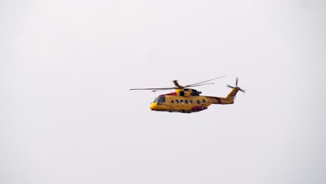 yellow rescue helicopter in flight