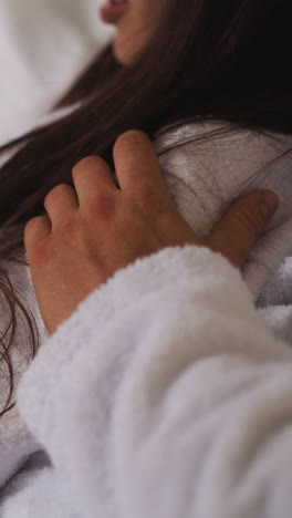 man hugs woman reading book in bed closeup. loving couple reads romantic novel resting in home bedroom at night. cozy relationship moments