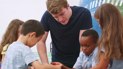 kids and teacher make earth science puzzle at science centre