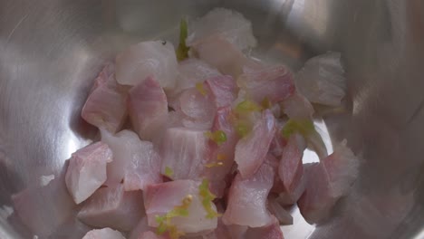 seasoning the fish for teh ceviche with chili