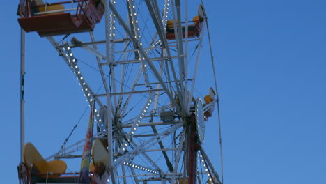 4k view of ferris wheel rides rotating, spinning in amusement park