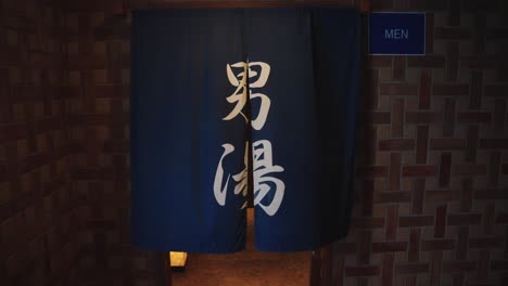 japanese bathhouse, slow tilt of male entrance to onsen baths