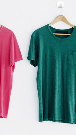 t-shirts hanging on white wall