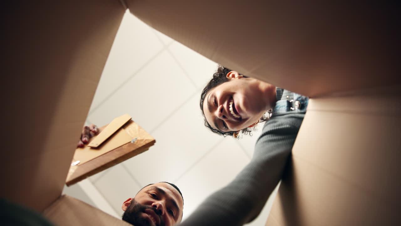 People looking into a cardboard box