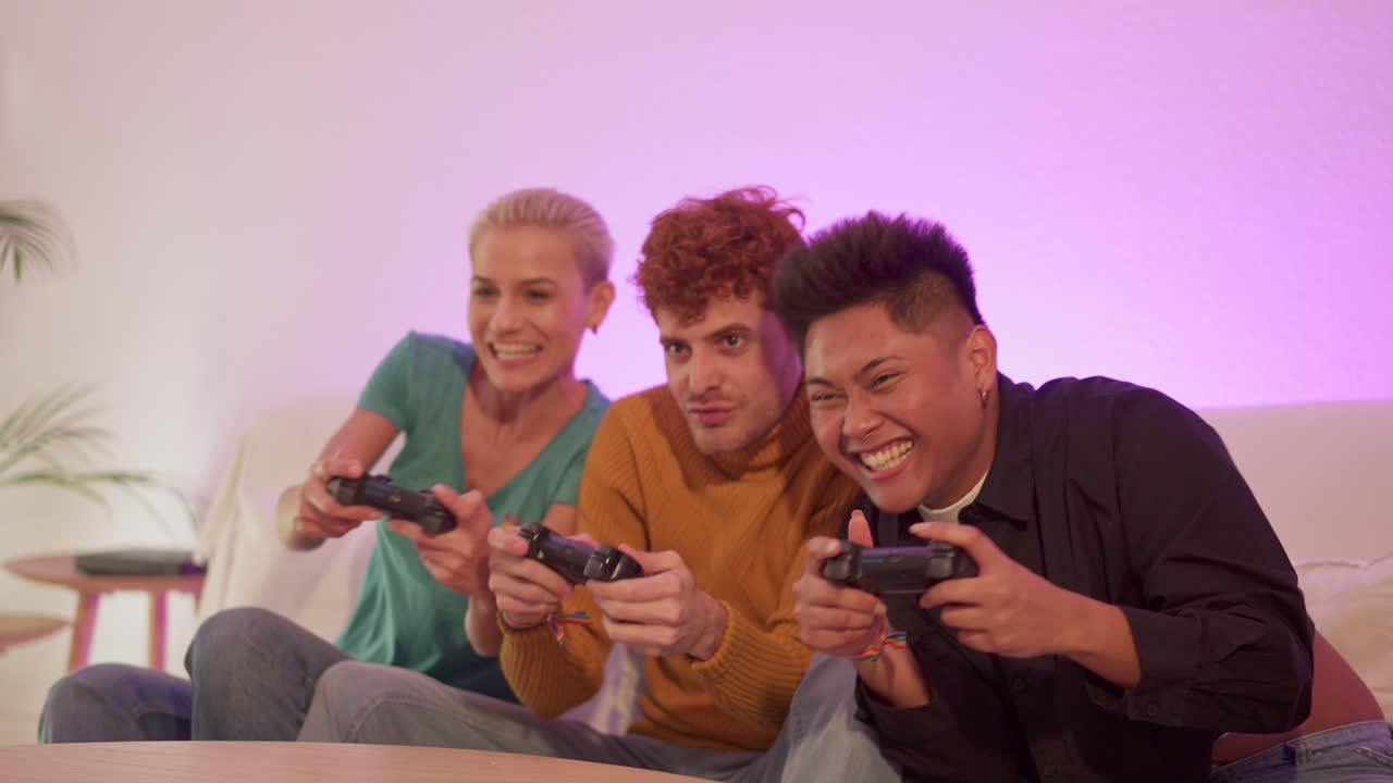 Friends enthusiastically playing video games on a couch