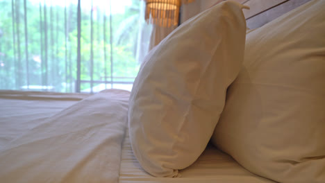 white pillow decoration on bed in bedroom interior