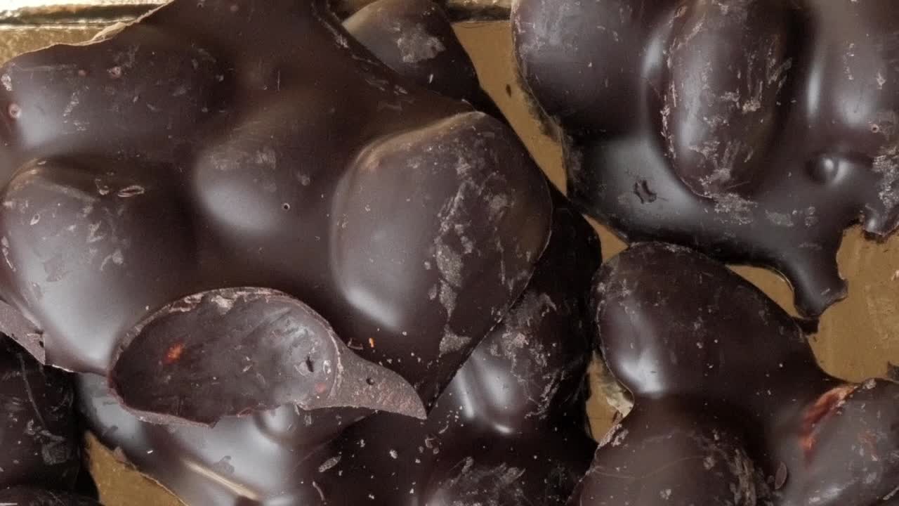 Delicious chocolate almonds in rich, glossy appearance, tempting treat