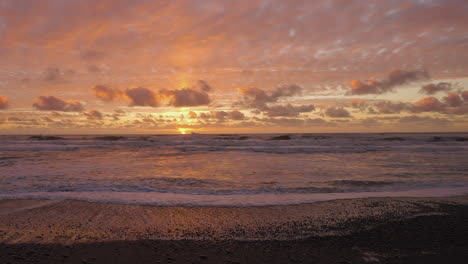 foamy sea waves against illuminated sky during golden hour