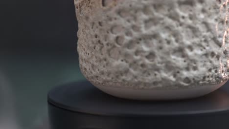 close-up macro of a bottom of ceramic glass with coral texture twisting around its axis