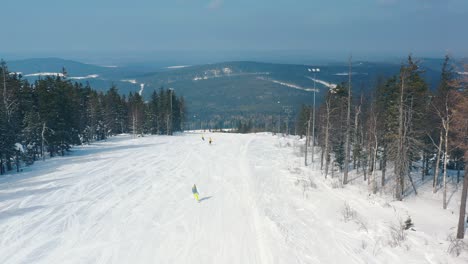 skiers on a snowy mountain slope