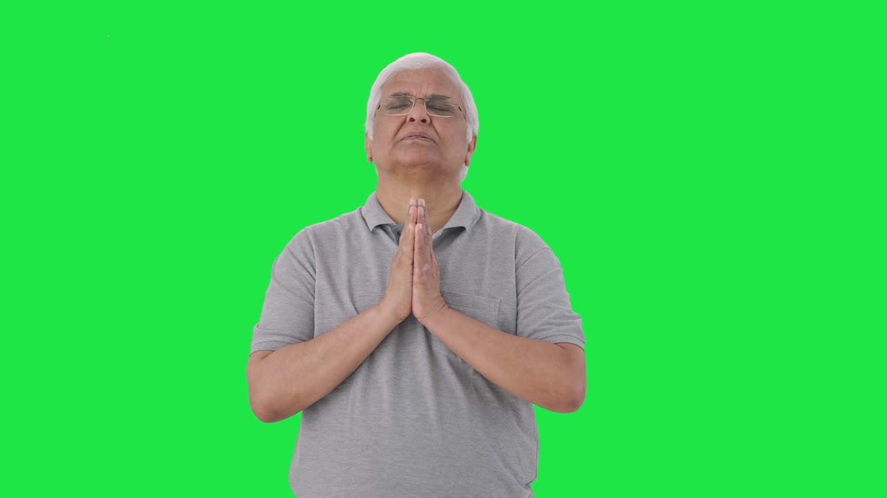 Religious Indian old man praying to God Green screen
