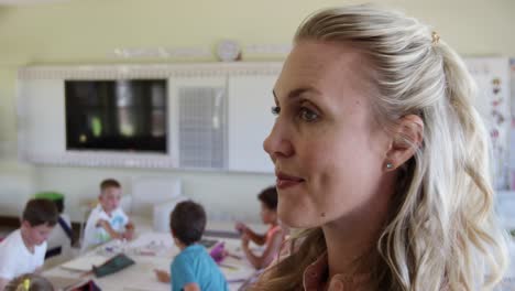 Female-teacher-smiling-in-the-class