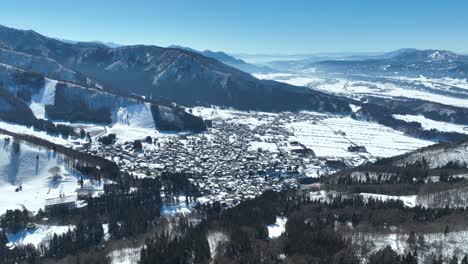 aerial establishing shot of japans nozawaonsen mountain ski resort village