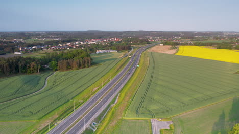 Aerial-view-of-highway-S6-through-lush-farm-landscape-in-Kielno,-Gdynia,-Poland