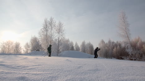 people skiing or snowshoeing in a snowy winter forest