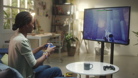 young woman enjoying video games in her living room