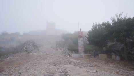 pan establishing shot of marvão village hidden by mist