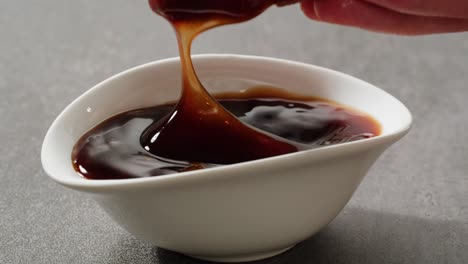 dipping fried chicken wings in sauce