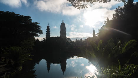 beautiful chinese buddhist temple pagodas time lapse, sunny cloudscape over lake