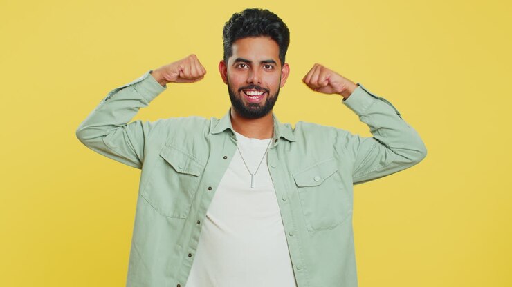 Man looking confident showing biceps, feeling power strength to fight for rights, success win