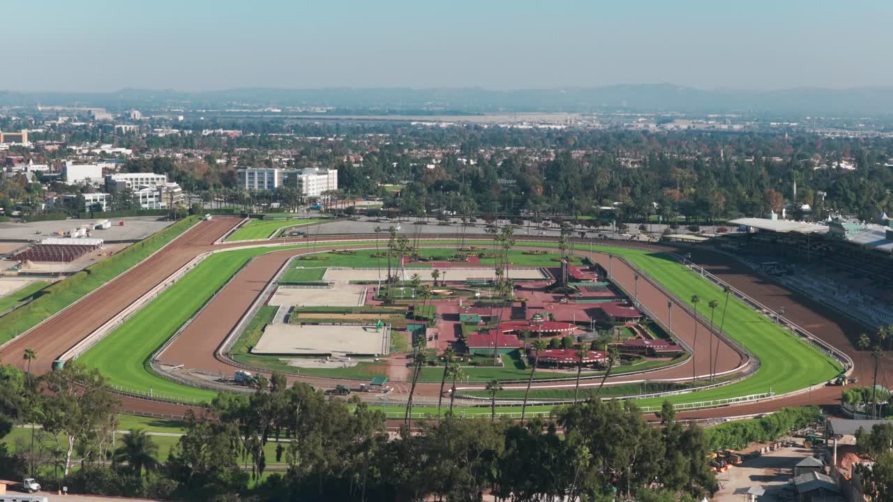 Telephoto aerial reverse pullback shot of the racetrack at Santa Anita Park in Los Angeles, California. 4K