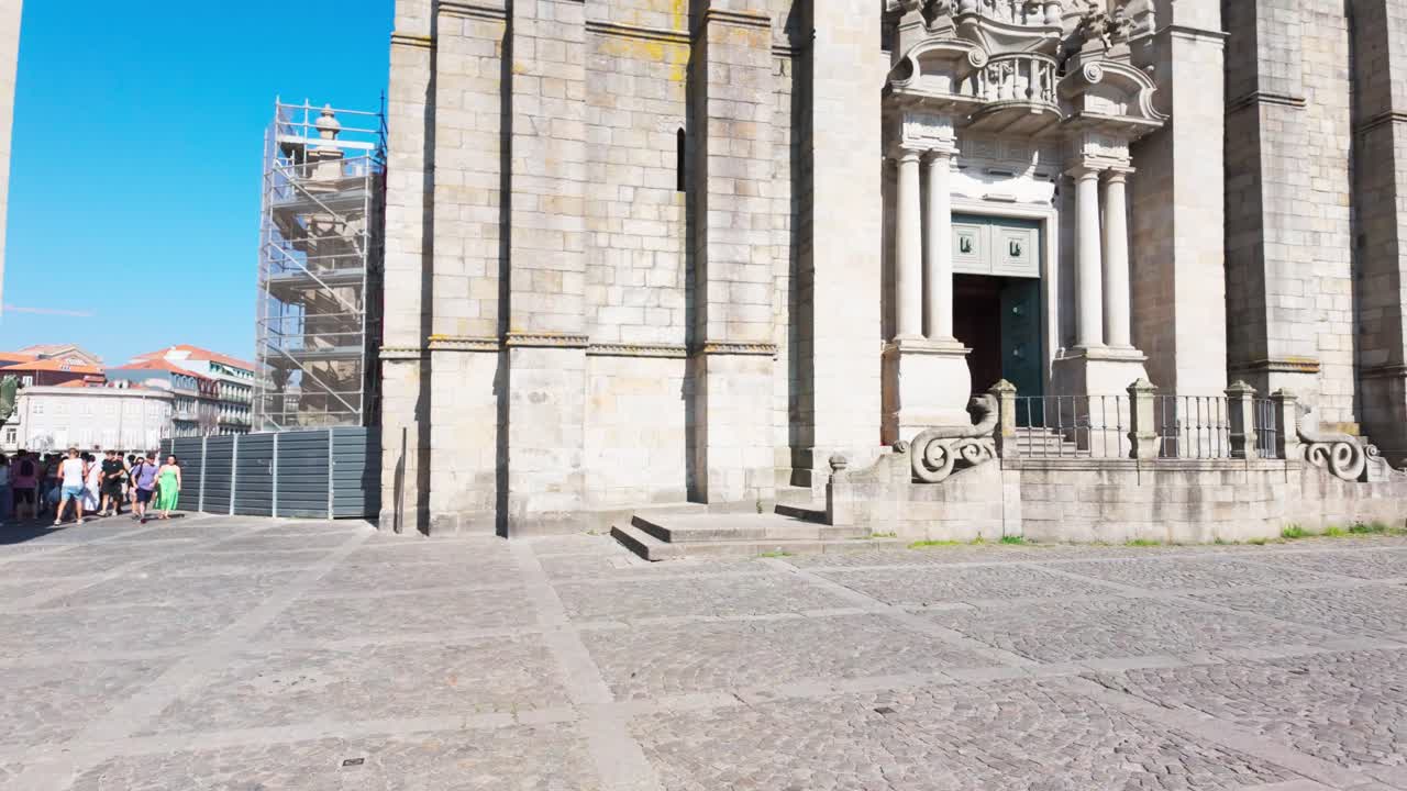 Porto Cathedral on a sunny day with few tourists, showing intricate stone architecture