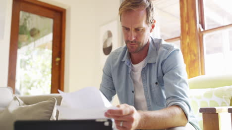 a young man using a digital tablet while sorting