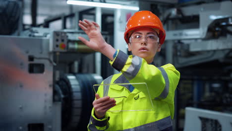 industrial woman using gadget with modern glass technologies for project work.