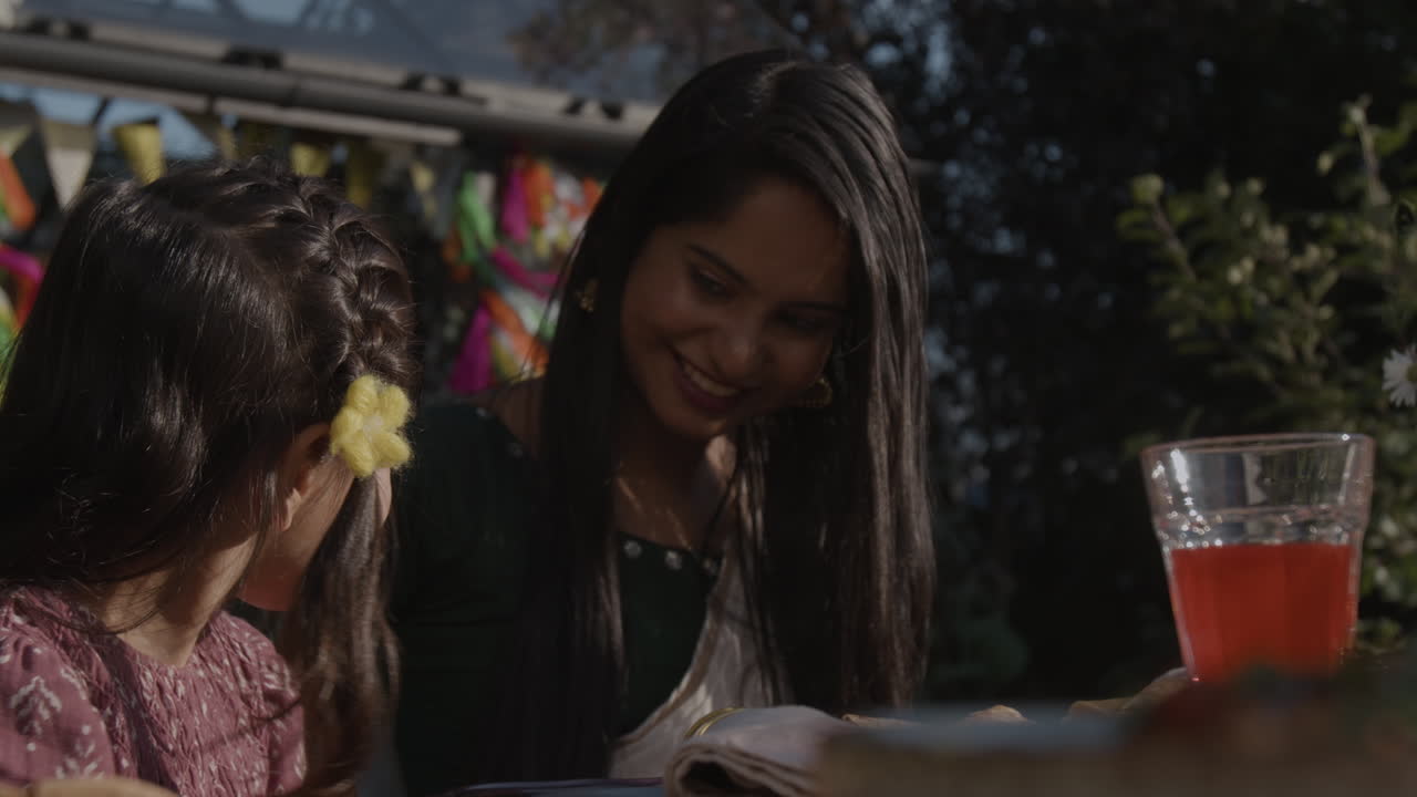 A woman and child at an outdoor celebration