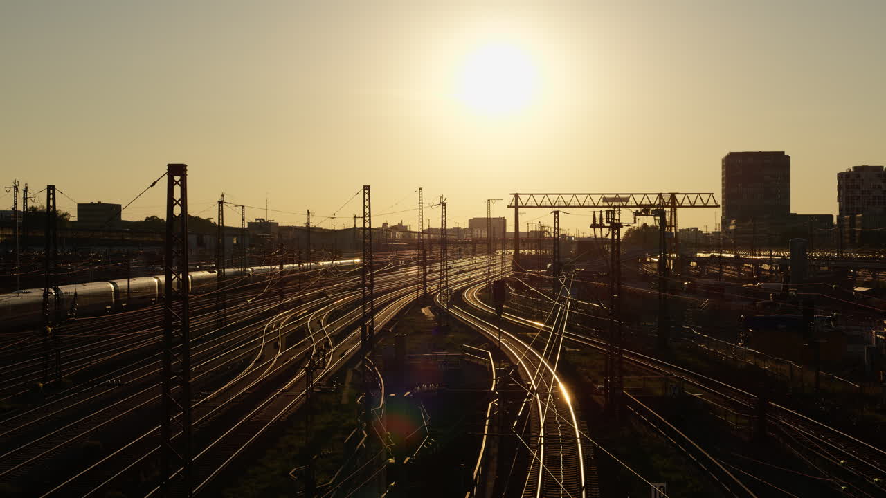 Wide view of train tracks during a golden hour sunset