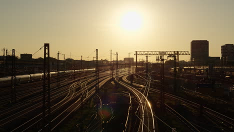 wide view of train tracks during a golden hour sunset