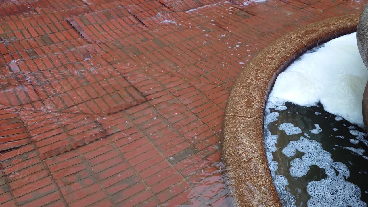 Rain water getting into fountain with foam in Hong Kong, China